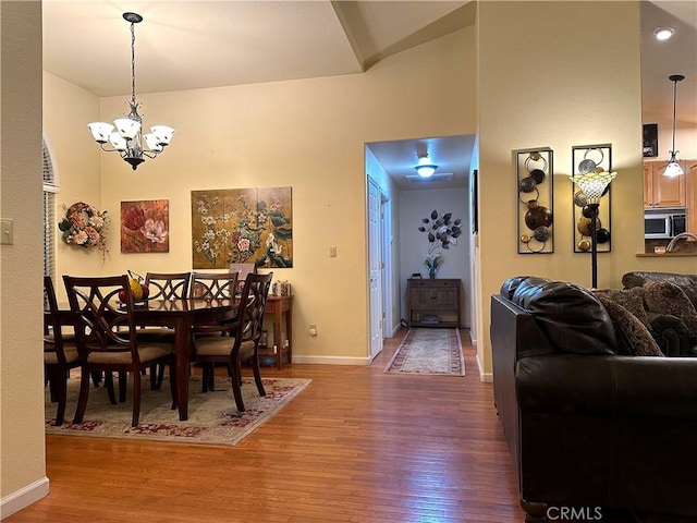 dining room featuring hardwood / wood-style floors and a chandelier