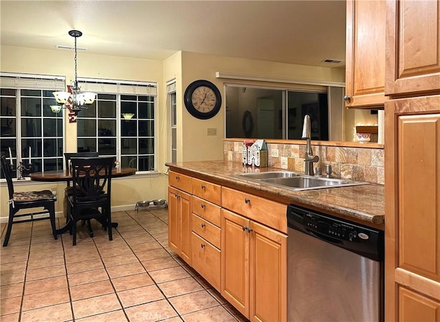 kitchen with pendant lighting, dishwasher, sink, light tile patterned floors, and a notable chandelier