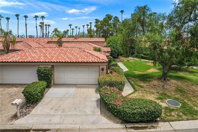 view of front facade featuring a front yard and a garage