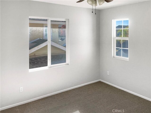 carpeted spare room featuring ceiling fan