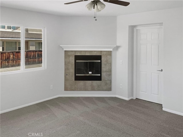 unfurnished living room with ceiling fan, carpet, baseboards, and a healthy amount of sunlight