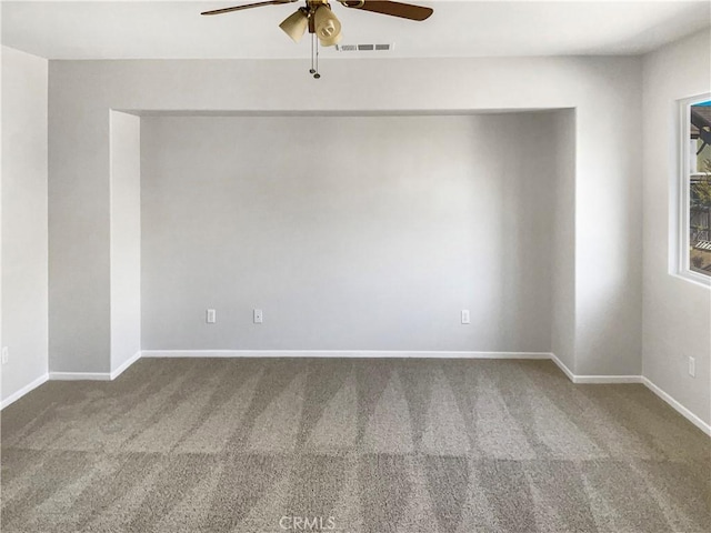 empty room with ceiling fan and carpet