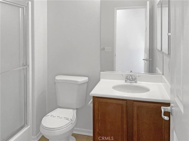 full bathroom with toilet, a shower with shower door, and vanity