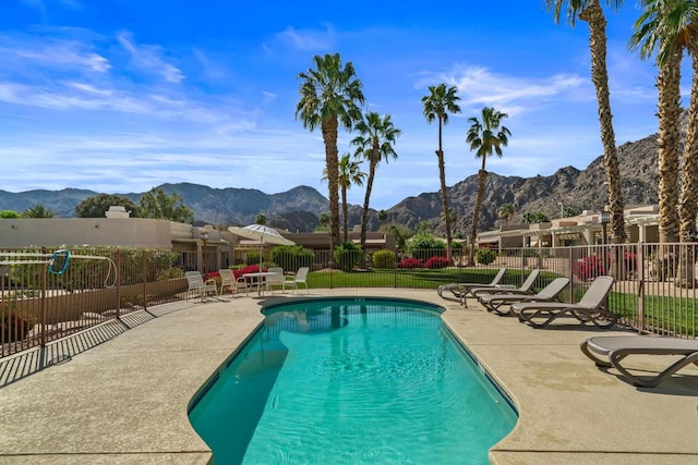 view of pool with a mountain view and a patio area