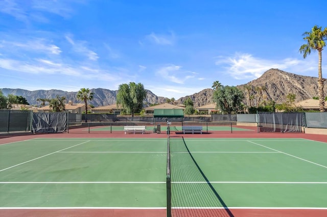 view of sport court featuring a mountain view and basketball hoop