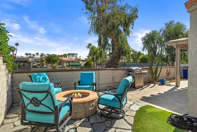 view of patio / terrace with a fire pit and grilling area