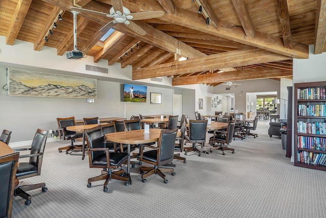 dining area with carpet, beam ceiling, rail lighting, and ceiling fan