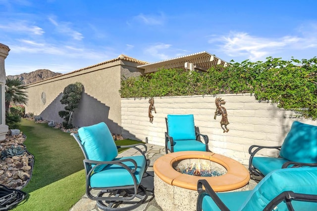 view of patio / terrace featuring a mountain view, a pergola, and a fire pit