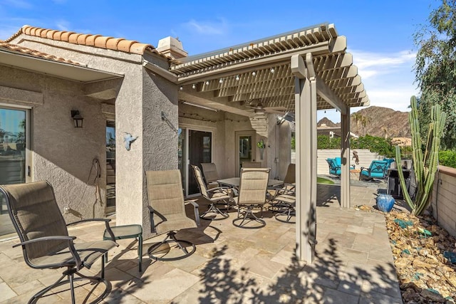 view of patio with a pergola and a mountain view