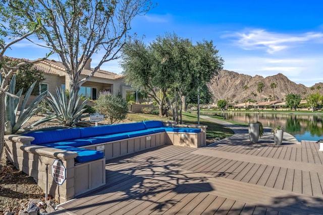 dock area featuring an outdoor hangout area and a water and mountain view