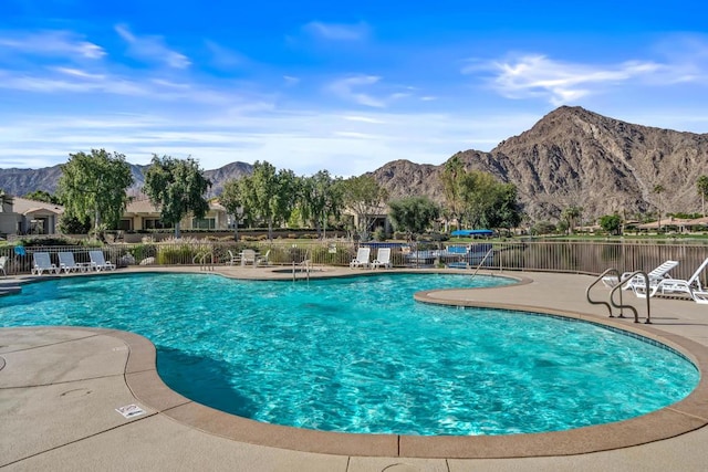 view of swimming pool with a mountain view and a patio