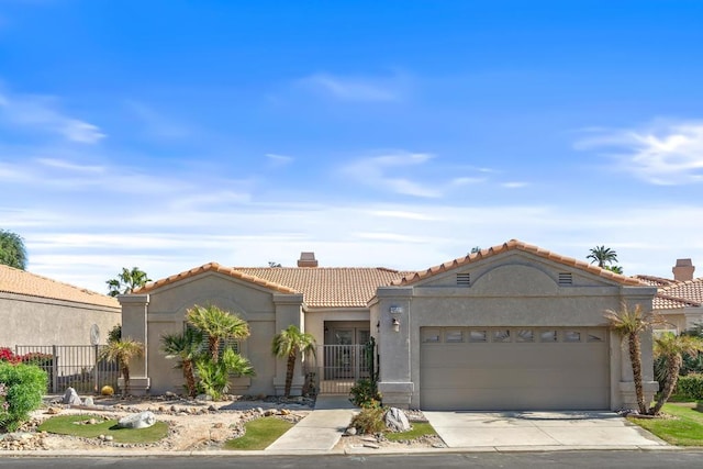 mediterranean / spanish-style home with a garage