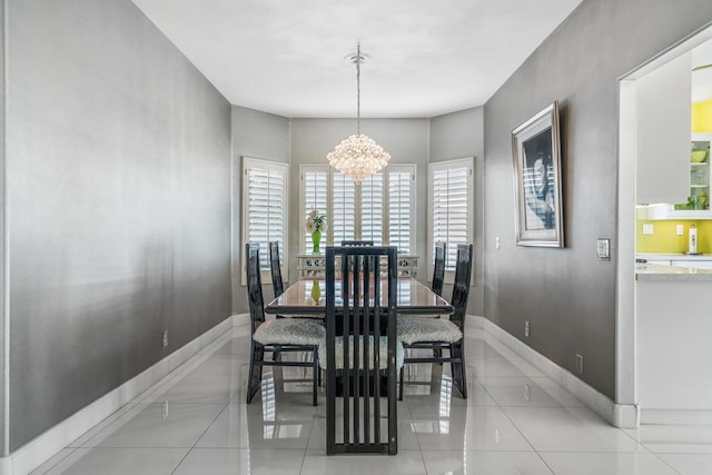 dining area featuring light tile patterned floors and a chandelier