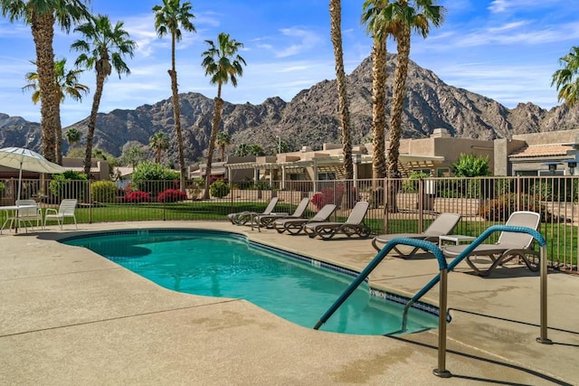 view of swimming pool with a mountain view and a patio area