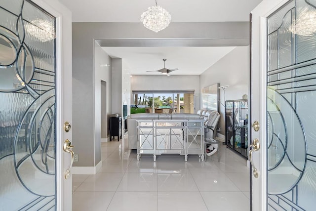 foyer entrance featuring ceiling fan with notable chandelier and light tile patterned flooring