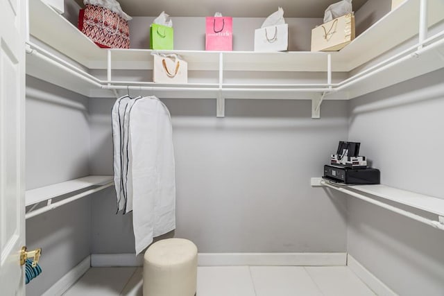 walk in closet with tile patterned flooring