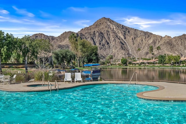 view of pool with a mountain view and a patio