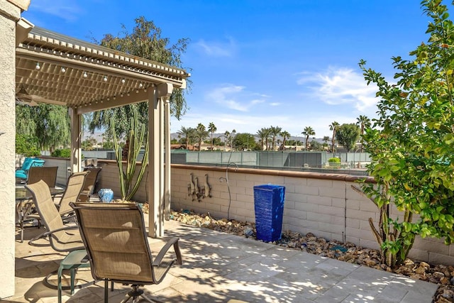 view of patio / terrace featuring a pergola and a water view