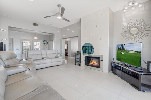 living room with ceiling fan, light tile patterned flooring, and french doors