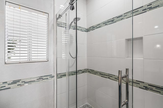 bathroom with a shower with shower door