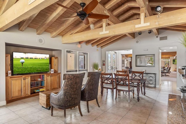 dining space with beam ceiling, ceiling fan, french doors, and high vaulted ceiling