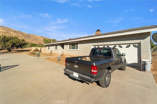 view of front facade with a mountain view and a garage