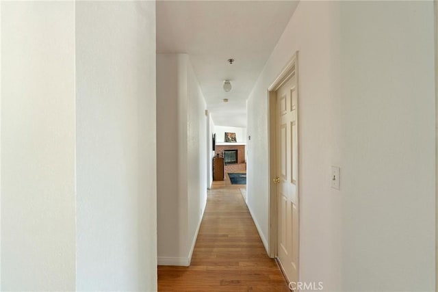 corridor with light hardwood / wood-style floors