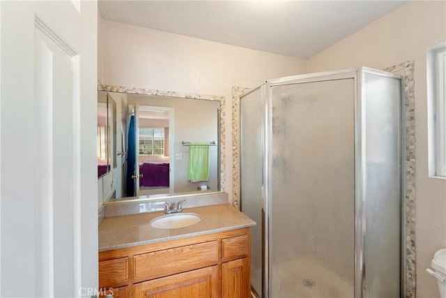 bathroom with vanity, a shower with shower door, and toilet