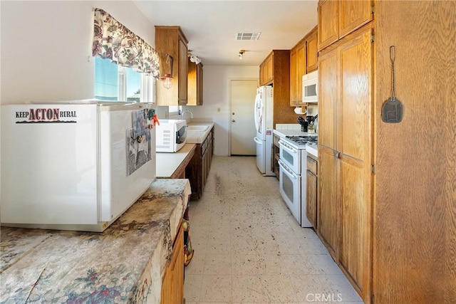 kitchen featuring sink and white appliances