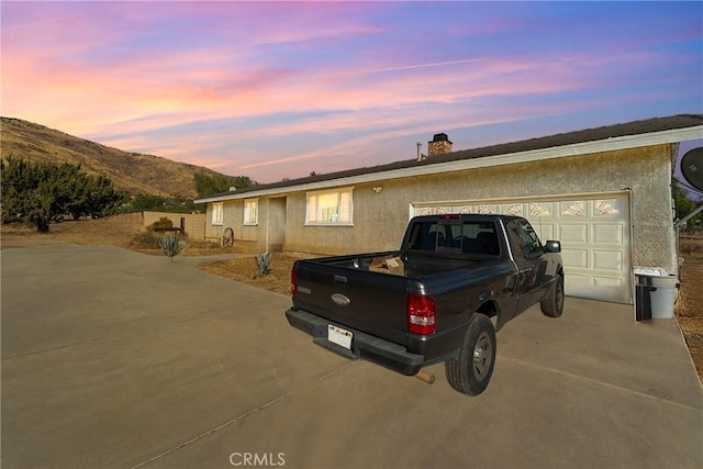 view of front of home featuring a mountain view and a garage