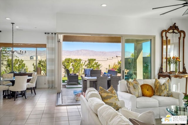 living room with a mountain view, a notable chandelier, and light tile patterned flooring