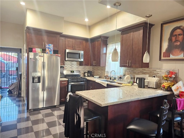 kitchen with a sink, decorative backsplash, light floors, a peninsula, and appliances with stainless steel finishes