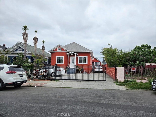 bungalow-style house with a gate and a fenced front yard