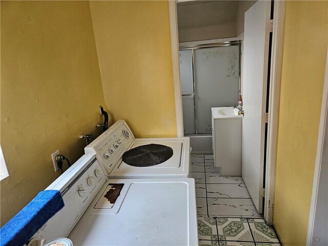 laundry room with separate washer and dryer and marble finish floor