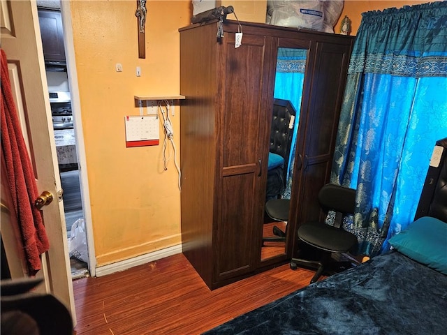 bedroom with wood finished floors and baseboards