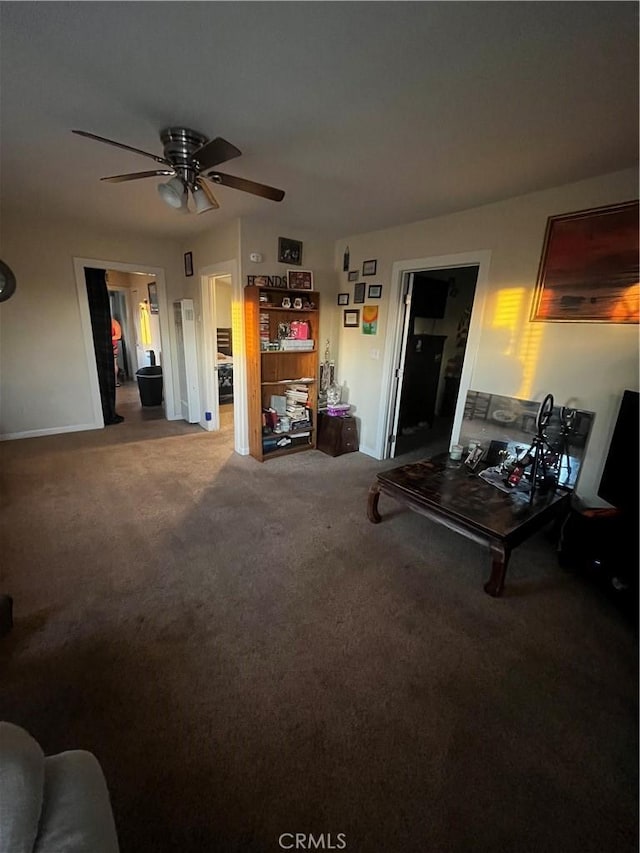 living room with ceiling fan and carpet floors