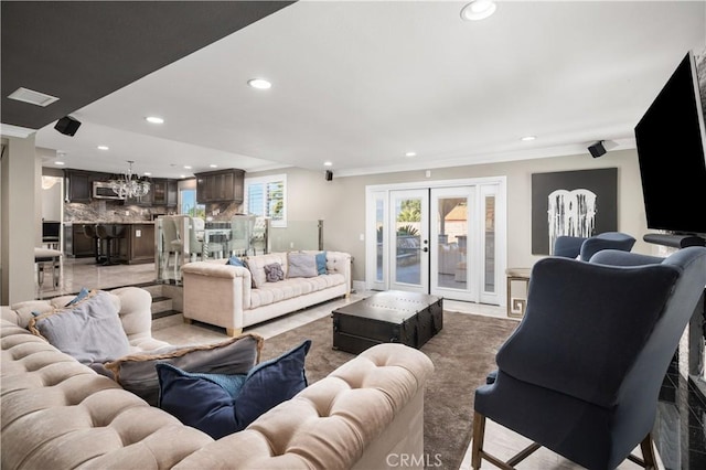 living room featuring a notable chandelier, recessed lighting, and visible vents