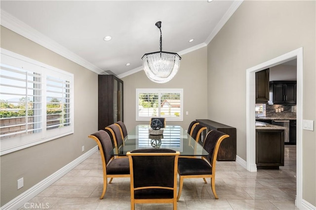 dining area featuring baseboards, a chandelier, and crown molding