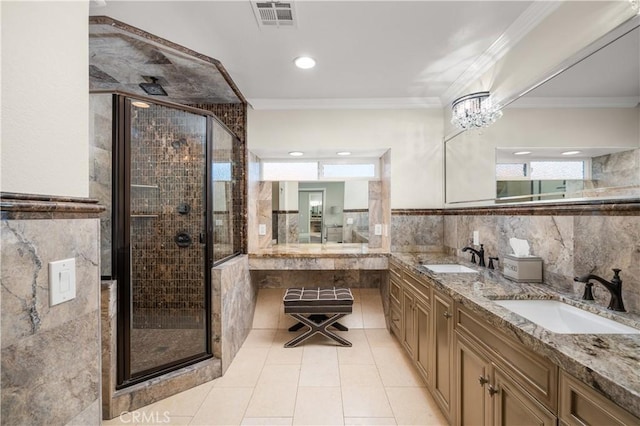 bathroom featuring vanity, crown molding, a notable chandelier, and a shower with door