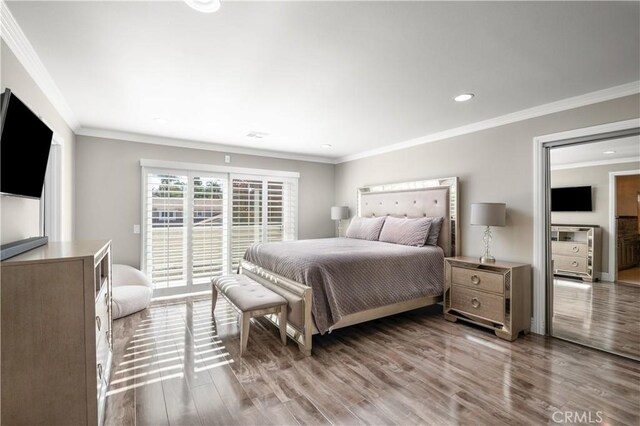 bedroom featuring crown molding and wood-type flooring