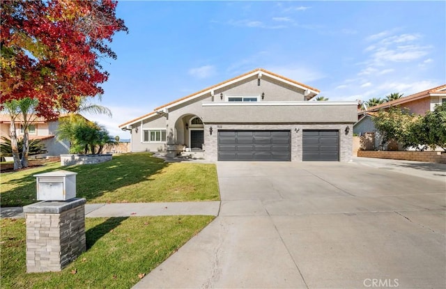 view of front of property with a front yard, concrete driveway, a garage, and stucco siding