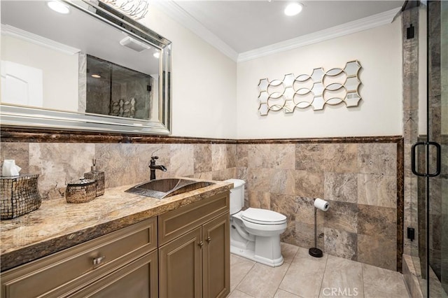 full bathroom with crown molding, toilet, vanity, a stall shower, and tile walls