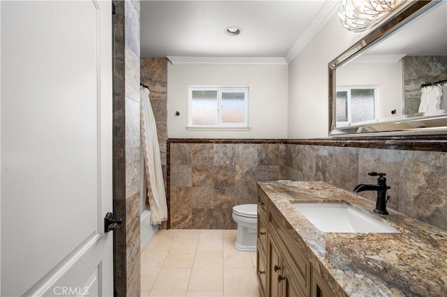 full bathroom featuring crown molding, tile patterned floors, tile walls, toilet, and vanity