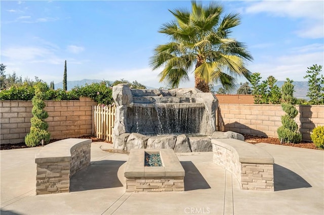 view of patio / terrace with fence and an outdoor fire pit