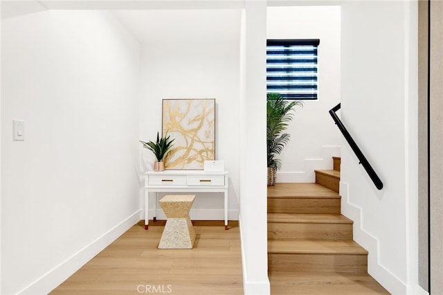 stairs featuring hardwood / wood-style flooring