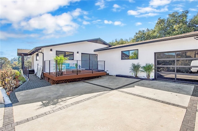 back of house with a wooden deck