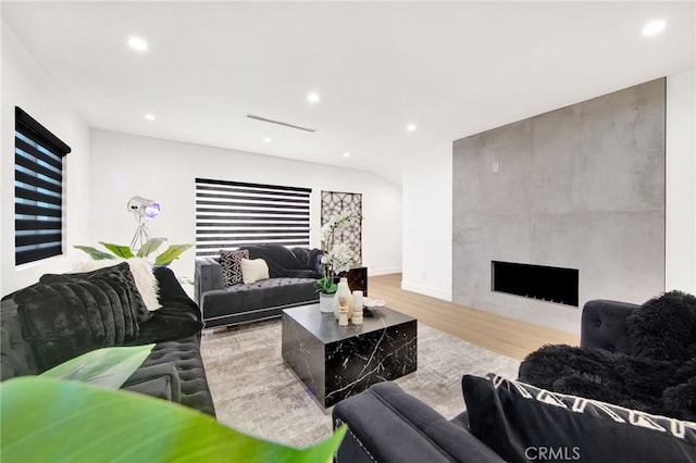 living room featuring a large fireplace and light hardwood / wood-style floors