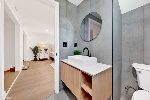 bathroom featuring hardwood / wood-style floors, vanity, and toilet