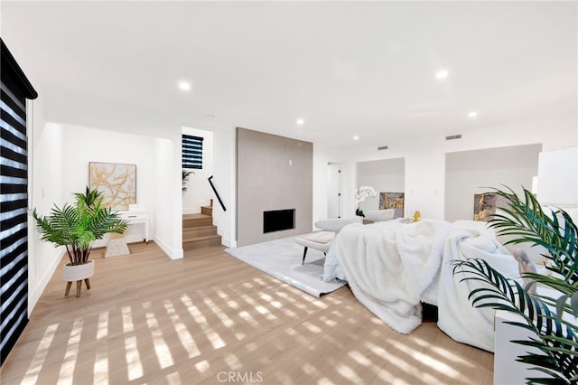 living room with a fireplace and light hardwood / wood-style floors