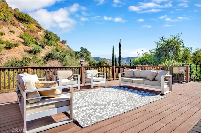 deck featuring a mountain view and an outdoor hangout area